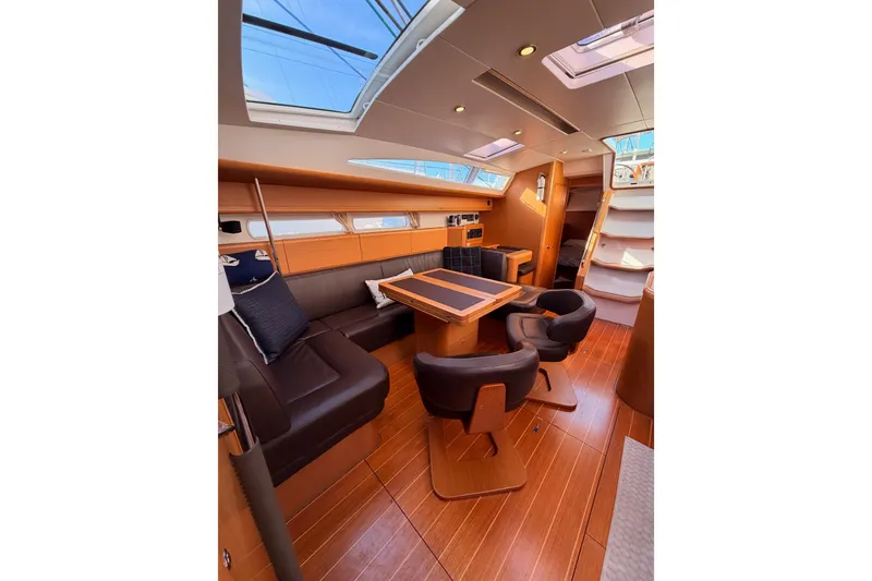 Slide: The Image of Luxurious interior of 2011 Jeanneau 53 yacht with elegant seating and wooden flooring. - 80