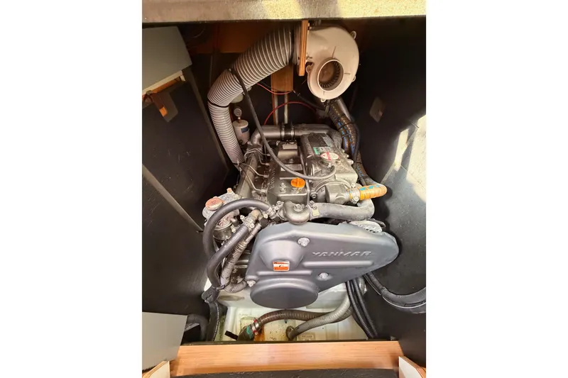 Slide: The Image of Engine compartment of a 2011 Jeanneau 53 sailboat, featuring a Yanmar engine. - 83