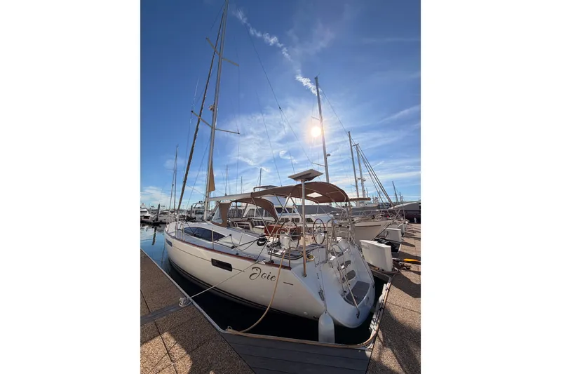 Slide: The Image of Jeanneau 53 sailboat, 2011 model, docked under a clear blue sky. - 9