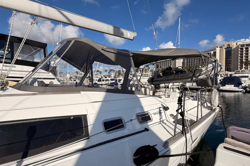 Slide: The Image of 2007 Beneteau 49 sailboat docked at marina under clear blue sky. - 10