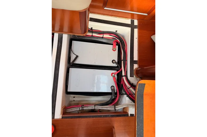 Slide: The Image of Battery compartment of a 2007 Beneteau 49 sailboat, featuring organized wiring. - 103