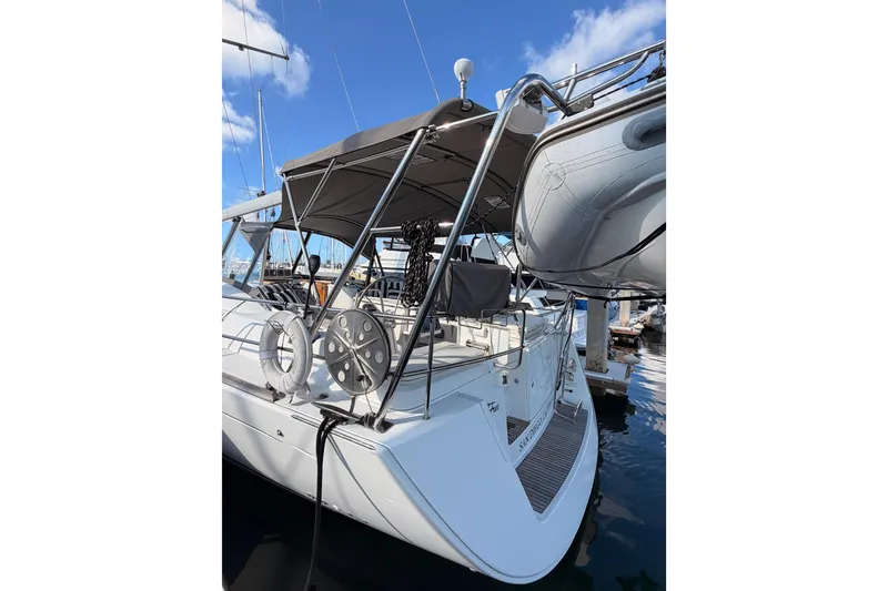 Slide: The Image of 2007 Beneteau 49 yacht docked, featuring a spacious deck and modern design. - 12