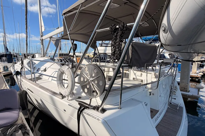 Slide: The Image of 2007 Beneteau 49 sailboat docked at marina, featuring spacious deck and modern design. - 13