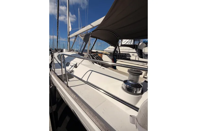 Slide: The Image of 2007 Beneteau 49 sailboat docked, featuring sleek deck design and modern rigging. - 14