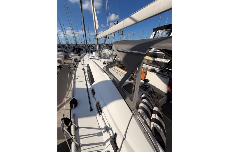Slide: The Image of 2007 Beneteau 49 sailboat docked at marina, showcasing sleek deck design and rigging. - 15