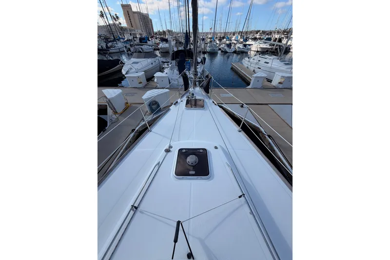 Slide: The Image of 2007 Beneteau 49 sailboat docked in a marina, surrounded by other boats. - 17