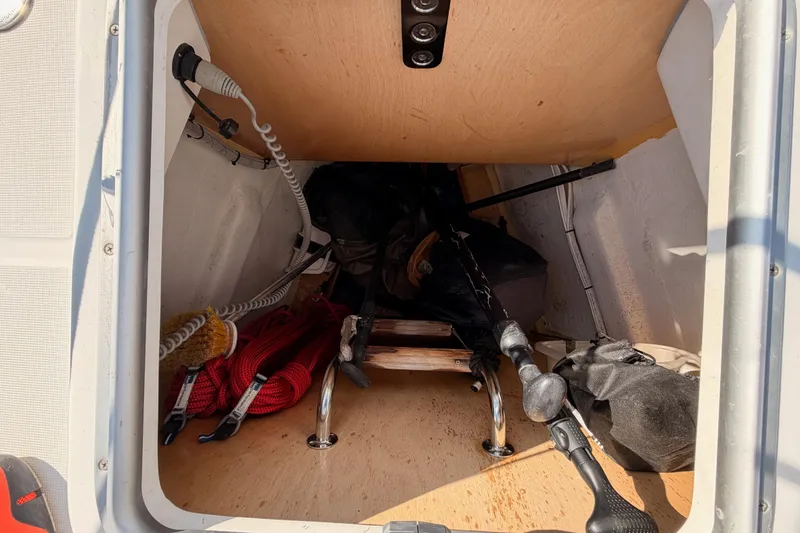 Slide: The Image of Storage compartment of a 2007 Beneteau 49 sailboat with ropes and equipment. - 19
