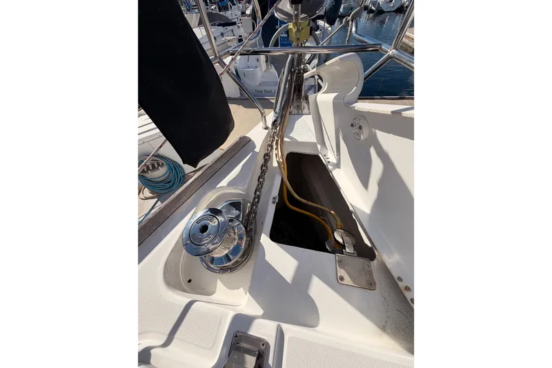 Slide: The Image of Deck view of a 2007 Beneteau 49 sailboat, featuring anchor chain and winch. - 20