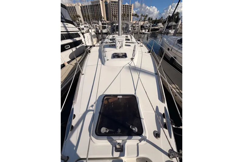Slide: The Image of 2007 Beneteau 49 sailboat deck view in marina, surrounded by other boats. - 24