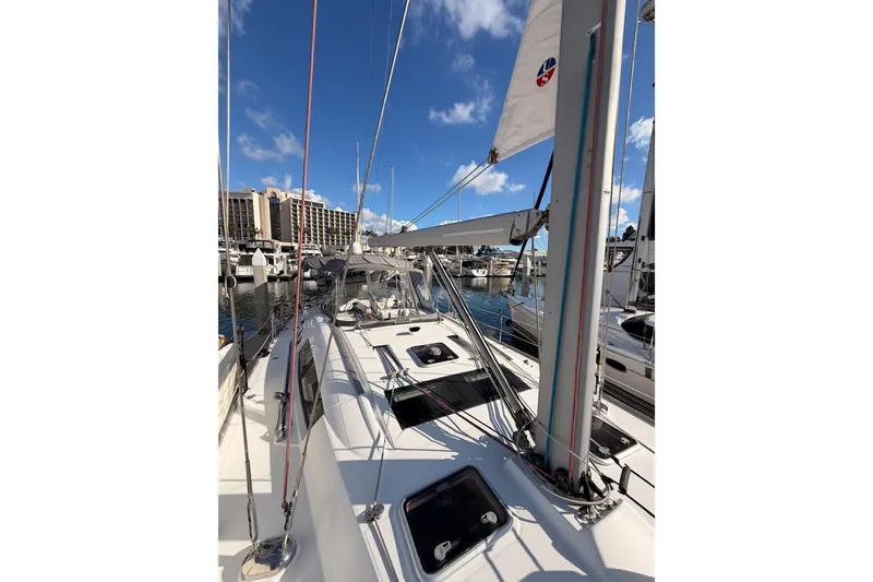 Slide: The Image of 2007 Beneteau 49 sailboat docked at marina under clear blue sky. - 25