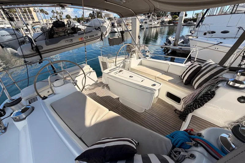 Slide: The Image of Spacious cockpit of a 2007 Beneteau 49 yacht with comfortable seating and nautical decor. - 27