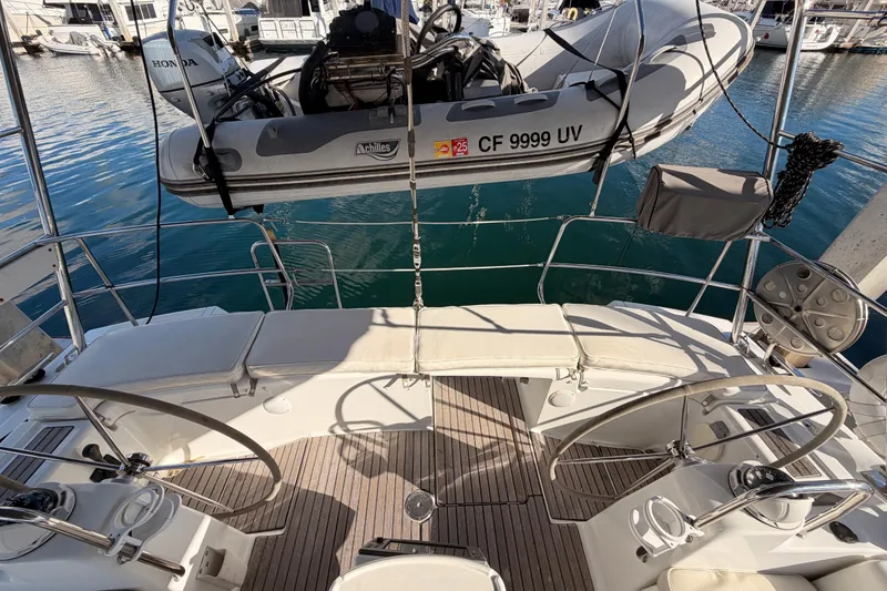 Slide: The Image of 2007 Beneteau 49 yacht cockpit with dual steering wheels and dinghy on davits. - 29