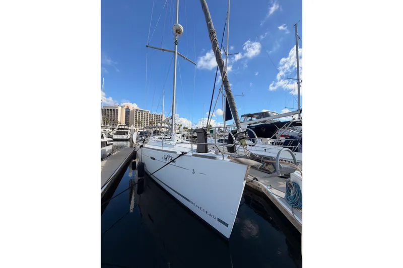 Slide: The Image of 2007 Beneteau 49 sailboat docked at marina under clear blue sky. - 3