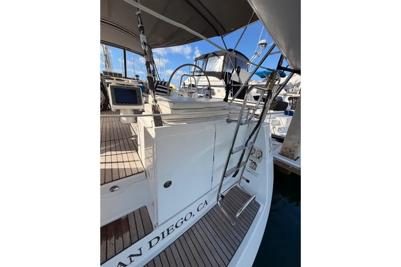 Slide: The Image of 2007 Beneteau 49 yacht docked in San Diego, featuring a sleek deck and helm. - 31