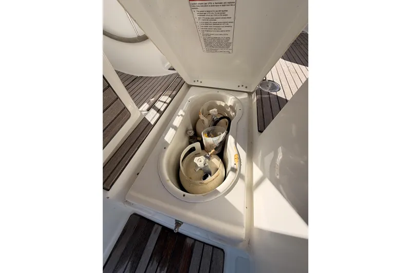 Slide: The Image of Storage compartment on 2007 Beneteau 49 yacht with propane tanks and wooden deck. - 33
