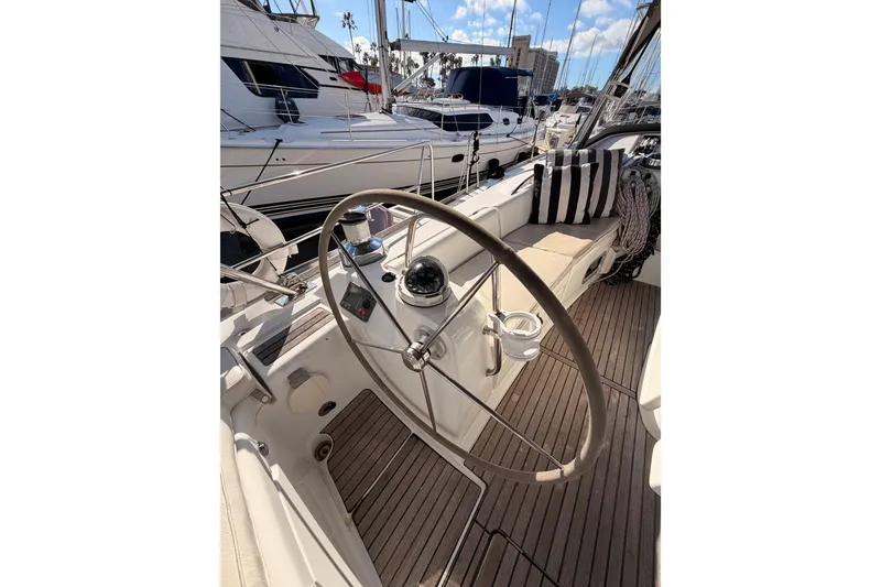 Slide: The Image of Steering wheel of a 2007 Beneteau 49 yacht, docked at a marina. - 34