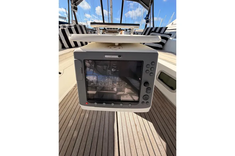 Slide: The Image of Navigation system on 2007 Beneteau 49 yacht, featuring striped seating and wooden deck. - 36