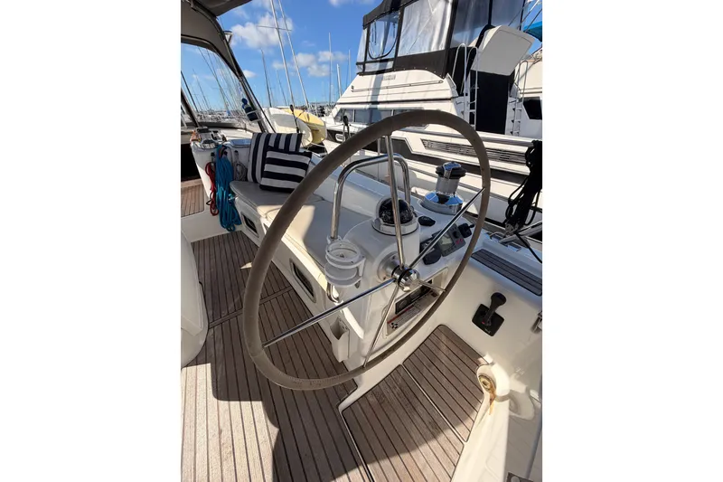 Slide: The Image of Cockpit of 2007 Beneteau 49 sailboat with steering wheel and nautical equipment. - 37