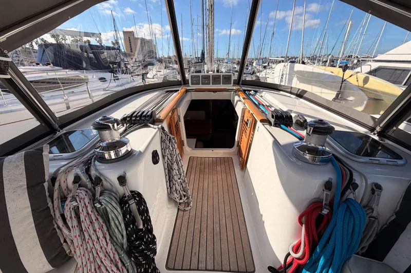 Slide: The Image of Cockpit view of 2007 Beneteau 49 sailboat, featuring ropes and winches in a marina setting. - 40