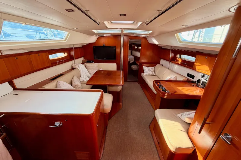 Slide: The Image of Luxurious interior of a 2007 Beneteau 49 yacht with elegant wood finishes and comfortable seating. - 45