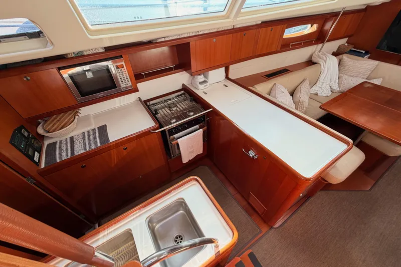 Slide: The Image of Luxurious 2007 Beneteau 49 yacht interior with modern kitchen and cozy seating area. - 46