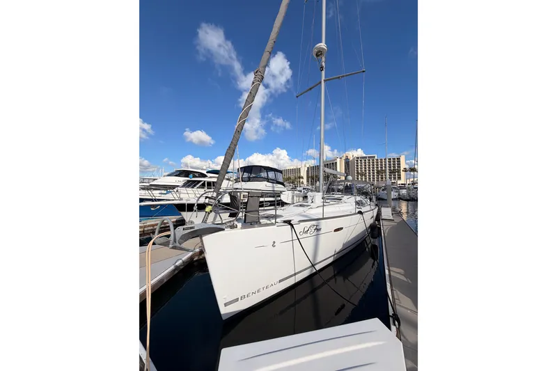 Slide: The Image of 2007 Beneteau 49 sailboat docked at marina under clear blue sky. - 5