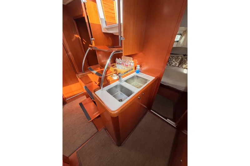 Slide: The Image of Interior of 2007 Beneteau 49 yacht featuring a compact kitchen area with sink. - 51
