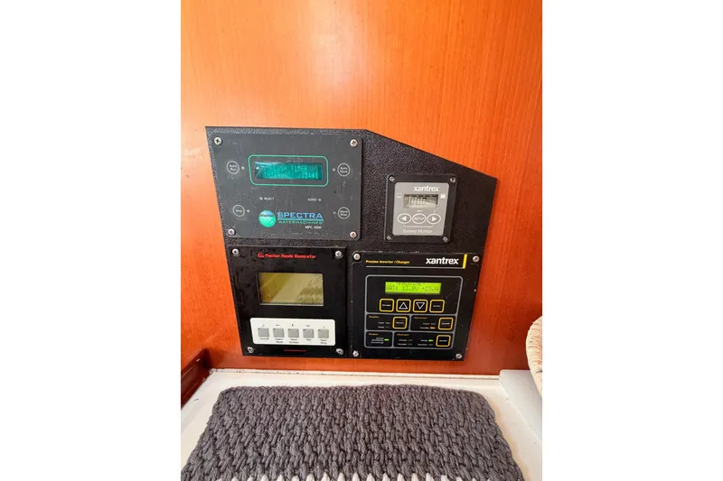 Slide: The Image of Control panel on a 2007 Beneteau 49 yacht featuring Xantrex and Spectra systems. - 56