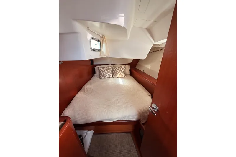 Slide: The Image of Cozy cabin interior of 2007 Beneteau 49 yacht with bed and porthole. - 57