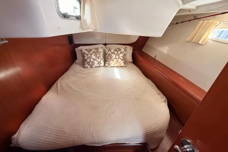 Slide: The Image of Cozy cabin interior of 2007 Beneteau 49 yacht with double bed and wooden finish. - 58