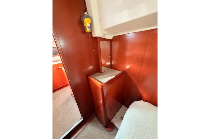Slide: The Image of Interior of 2007 Beneteau 49 yacht with wooden cabinetry and cozy sleeping area. - 60