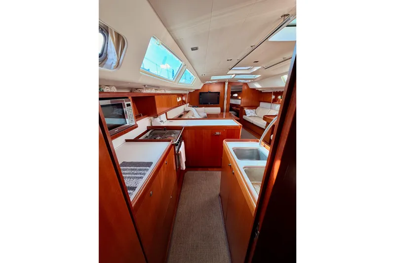 Slide: The Image of Luxurious interior of 2007 Beneteau 49 yacht with modern kitchen and seating area. - 61
