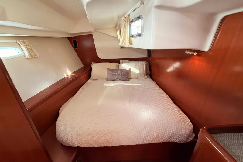 Slide: The Image of Cozy cabin interior of 2007 Beneteau 49 yacht with wooden accents and comfortable bedding. - 67