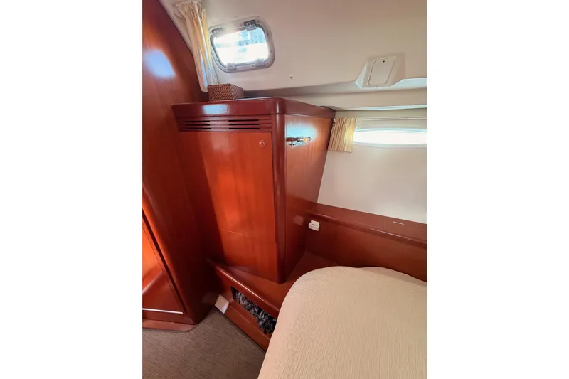 Slide: The Image of Interior cabin of 2007 Beneteau 49 yacht with wooden cabinetry and window. - 68