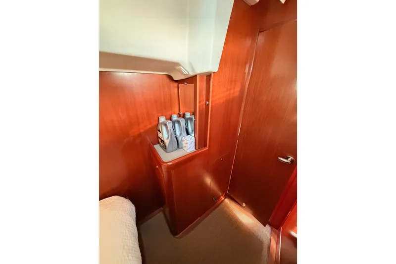 Slide: The Image of Interior of 2007 Beneteau 49 yacht with wooden paneling and storage area. - 69