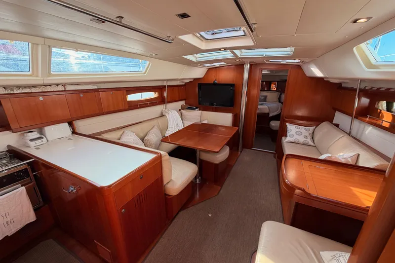 Slide: The Image of Luxurious interior of a 2007 Beneteau 49 yacht with elegant wood finishes and comfortable seating. - 72