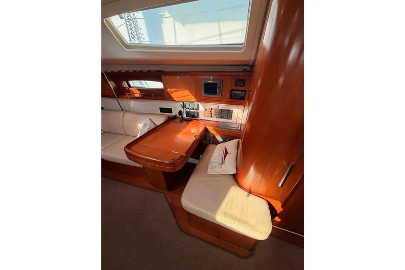 Slide: The Image of Interior of 2007 Beneteau 49 yacht with navigation station and seating area. - 73