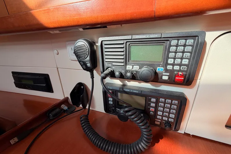 Slide: The Image of VHF marine radios on 2007 Beneteau 49 yacht, featuring Icom IC-M604 and IC-M802 models. - 75