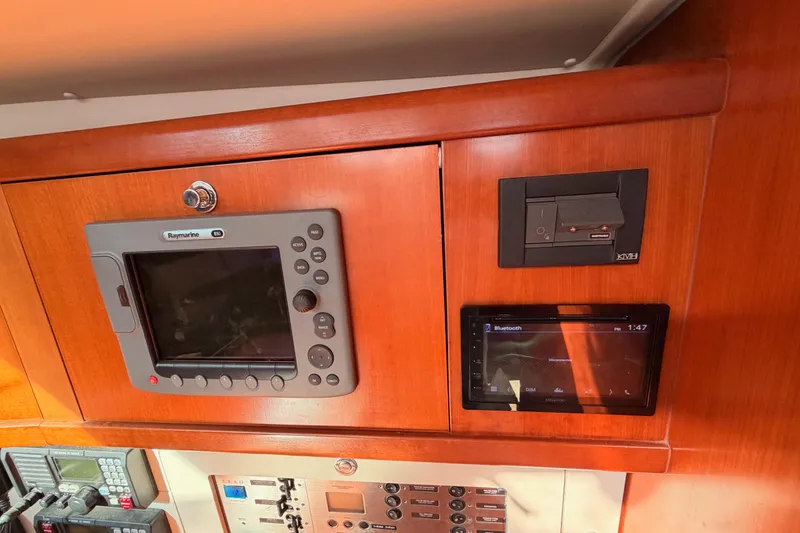 Slide: The Image of Control panel of a 2007 Beneteau 49 yacht with navigation and audio systems. - 77