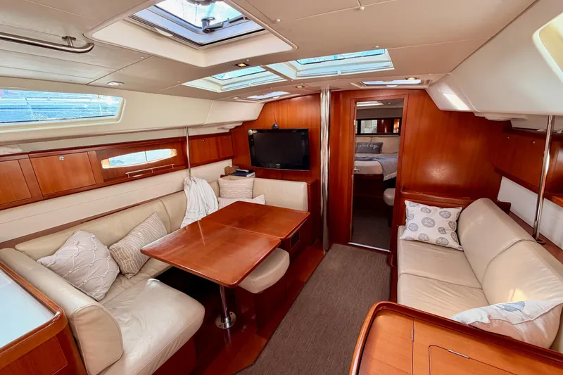 Slide: The Image of Luxurious interior of a 2007 Beneteau 49 yacht with elegant wood finishes and comfortable seating. - 78