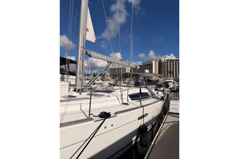 Slide: The Image of 2007 Beneteau 49 sailboat docked at marina under clear blue sky. - 8