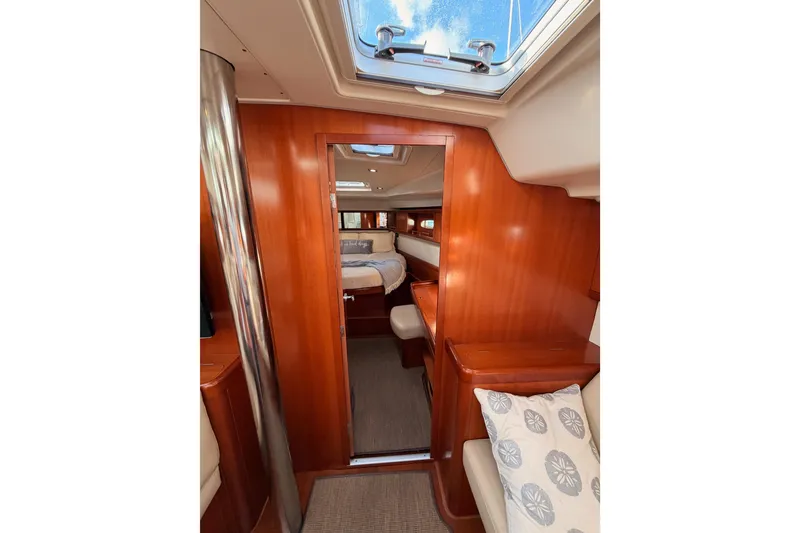 Slide: The Image of Interior of 2007 Beneteau 49 yacht, featuring wood paneling and cozy cabin space. - 83