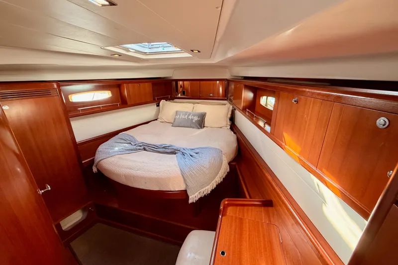 Slide: The Image of Luxurious 2007 Beneteau 49 yacht cabin with cozy bed and elegant wood finish. - 85