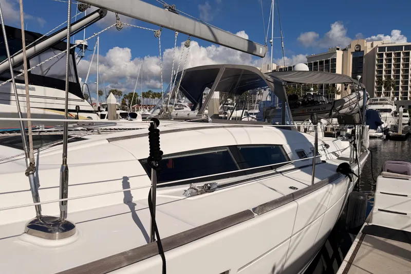 Slide: The Image of 2007 Beneteau 49 sailboat docked at marina under clear blue sky. - 9