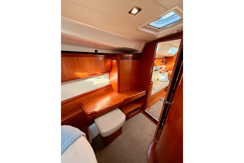 Slide: The Image of Luxurious interior of 2007 Beneteau 49 yacht with wooden finish and cozy cabin. - 90