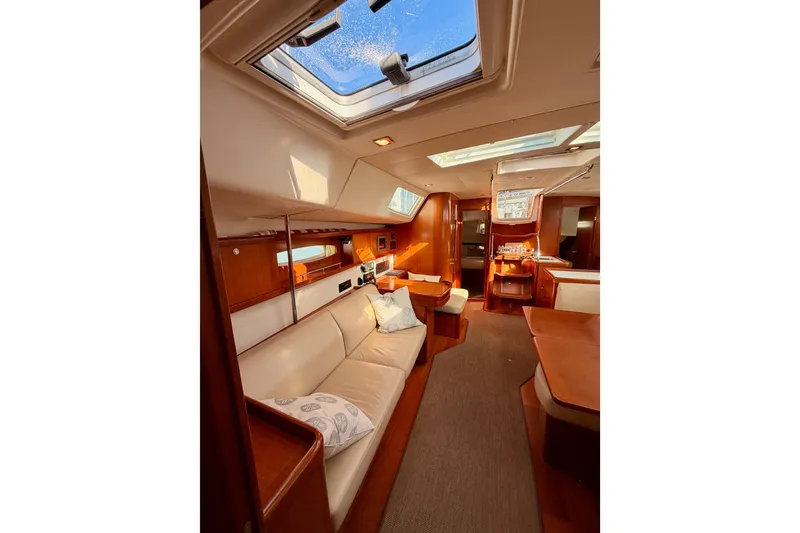 Slide: The Image of Luxurious interior of a 2007 Beneteau 49 yacht with elegant wood finishes and skylights. - 91