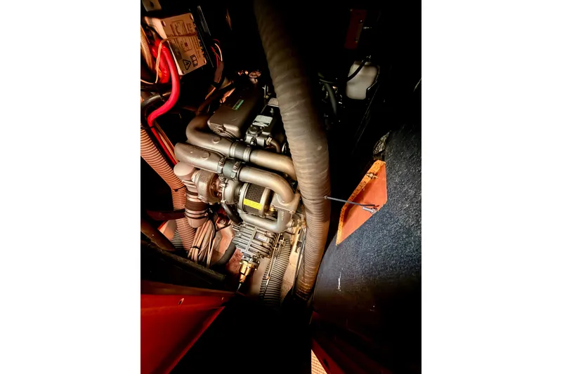 Slide: The Image of Engine compartment of a 2007 Beneteau 49 sailboat, showcasing mechanical components. - 98