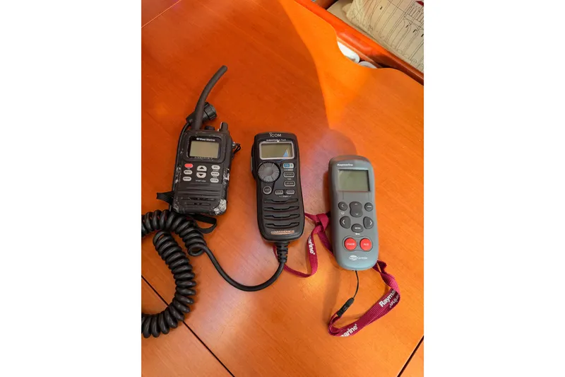 Slide: The Image of Three marine communication devices on a wooden surface, suitable for a 2007 Beneteau 49 yacht. - 99