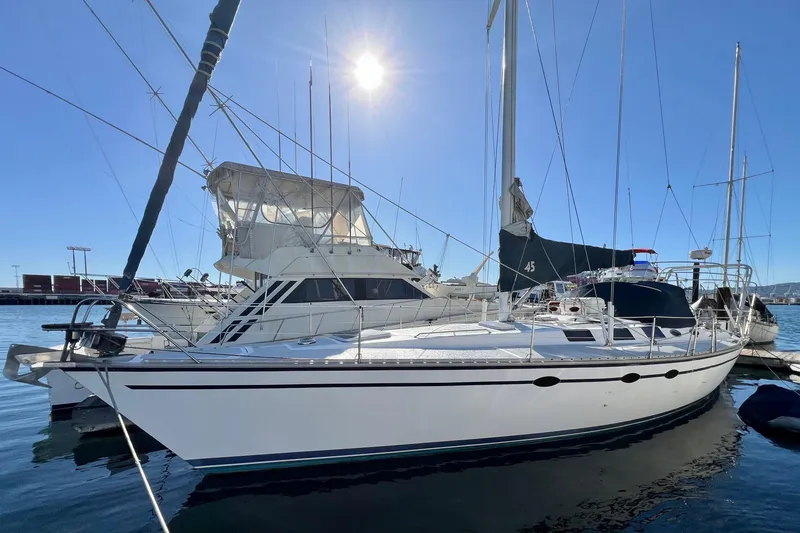 The Image of 1986 Hunter Legend 45 sailboat docked in sunny marina. - 1