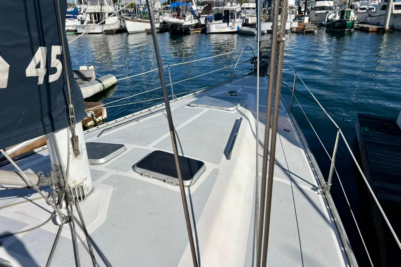 Slide: The Image of 1986 Hunter Legend 45 sailboat docked in a marina, showcasing deck and rigging. - 10